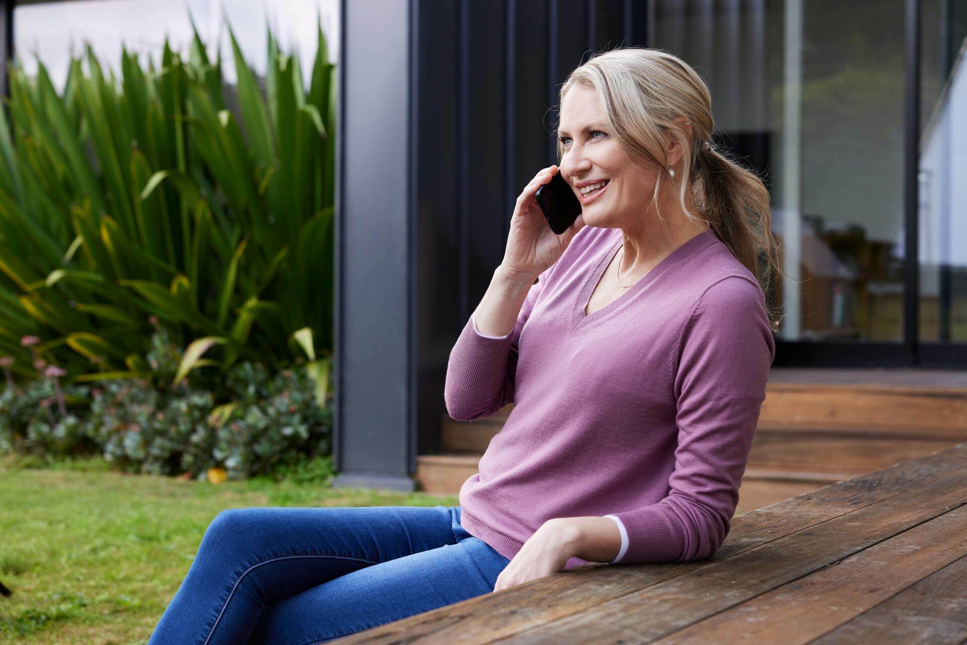 Woman sitting outside talking on the phont